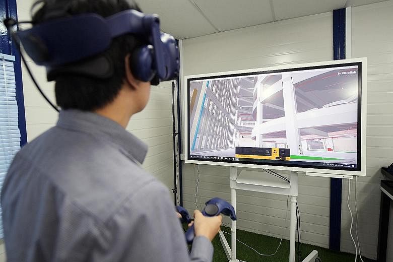 Boustead Projects building information modelling coordinator Tan Teck Seng walking through a virtual reality simulation of a 3D model of what Kranji Green should look like when it is completed.