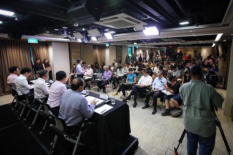 Social and Family Development Minister Desmond Lee (standing) speaking about his ministry's measures at a press conference by the multi-ministry task force on the Wuhan virus yesterday. Seated behind him are (from left) Education Minister Ong Ye Kung