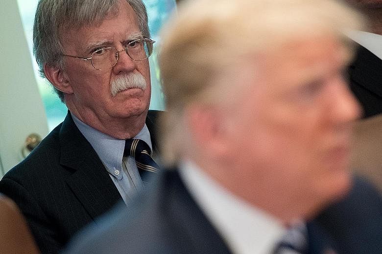 A 2018 file photo of US President Donald Trump and his then national security adviser John Bolton during a Cabinet meeting. PHOTO: AGENCE FRANCE-PRESSE