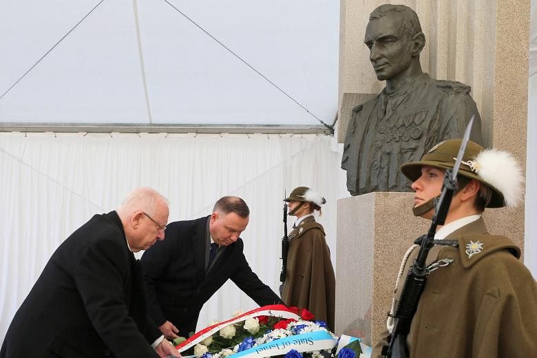 (From left) Israeli President Reuven Rivlin and Polish President Andrzej Duda laying flowers at the Witold Pilecki monument in Poland yesterday. PHOTO: EPA-EFE