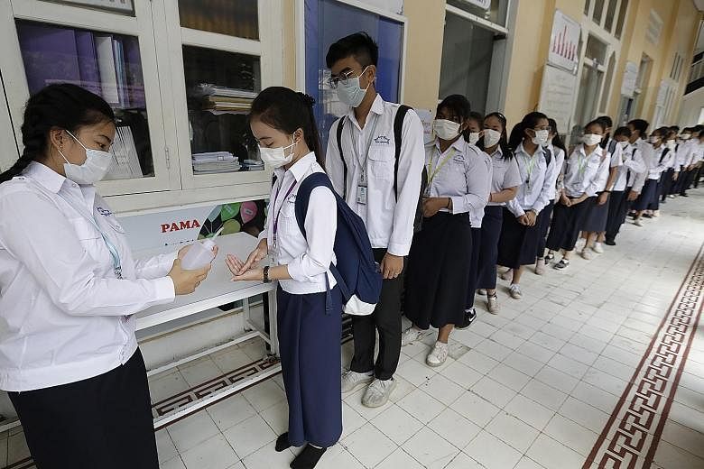 Cambodian students getting their hands sanitised at a school in Phnom Penh yesterday. Cambodia said its health authorities had found a Chinese national infected with the coronavirus in Sihanouk province.