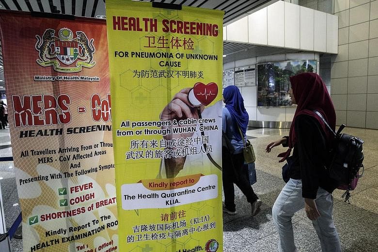 A poster on screening for the Wuhan coronavirus at Kuala Lumpur International Airport. On Monday, Malaysia banned Chinese nationals from Hubei province from entering the country. No new confirmed cases of the virus have surfaced in Malaysia since fou