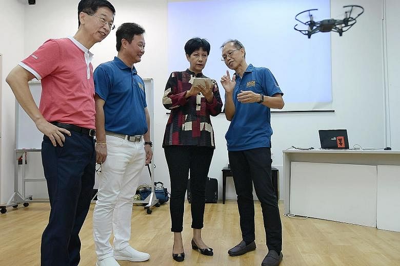 Minister in the Prime Minister's Office Indranee Rajah at a drone demonstration at RSVP Singapore yesterday. She was accompanied by (from left) Ministry of Culture, Community and Youth deputy secretary Ang Hak Seng, RSVP Singapore chairman Koh Juay M