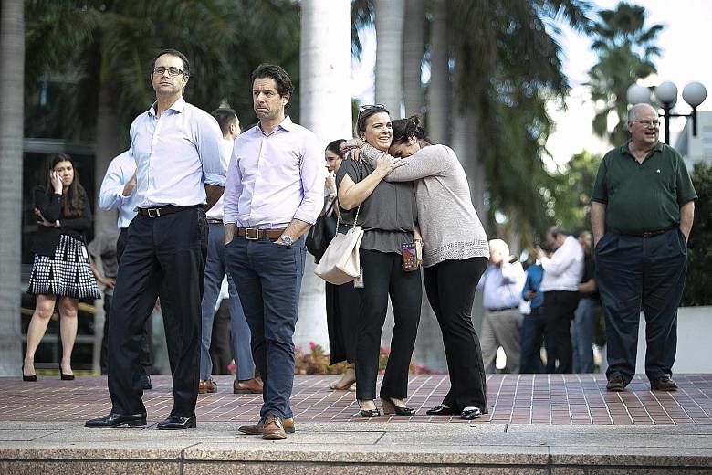 People in Miami, Florida, waiting outdoors on Tuesday after high-rise buildings shook as a major earthquake struck south of Cuba.