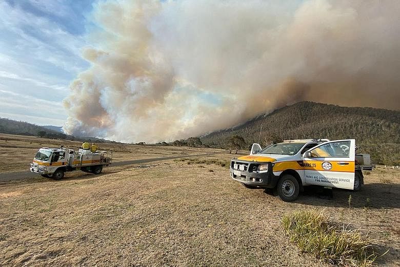 Prime Minister Scott Morrison says the chain of command between states and the federal government remains unclear, even as the authorities warn of fires sweeping through a national park near Canberra (left). PHOTOS: ACT EMERGENCY SERVICES AGENCY/ FAC