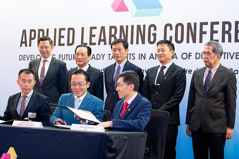 The memorandum of understanding for the training programme was signed yesterday by (sitting, from left) SMRT Trains chief executive Lee Ling Wee; SkillsFuture Singapore deputy chief executive for industry Michael Fung Jin Lung; and Associate Professo