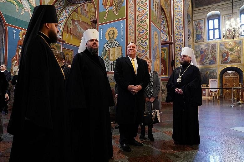 US Secretary of State Mike Pompeo and Metropolitan Yepifaniy (second from left), the leader of the new independent Ukrainian Orthodox Church, visiting the Mikhailovsky Zlatoverkhy Cathedral in Kiev yesterday.