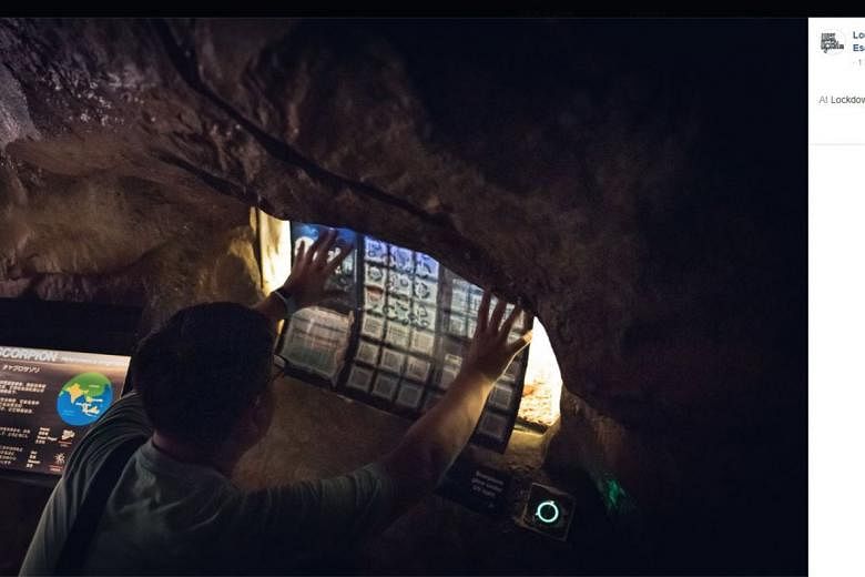 A player cracking a puzzle in an escape game held at the Night Safari last year. 