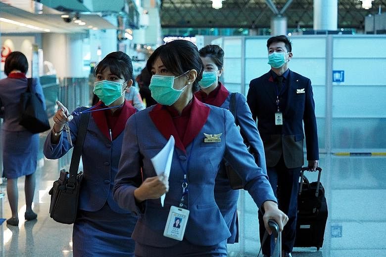 Flight attendants from Taiwan's China Airlines wearing protective masks at the Taoyuan International Airport in Taiwan last Thursday.