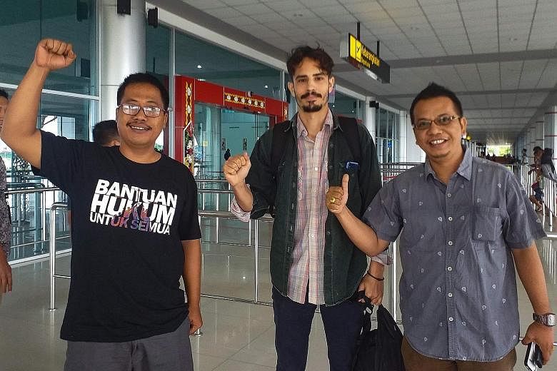 US journalist Philip Jacobson, flanked by lawyers Aryo Nugroho (left) and Parlin Bayu Hutabarat, at Palangkaraya airport in Central Kalimantan on Friday. He was detained 45 days earlier over alleged visa violations.