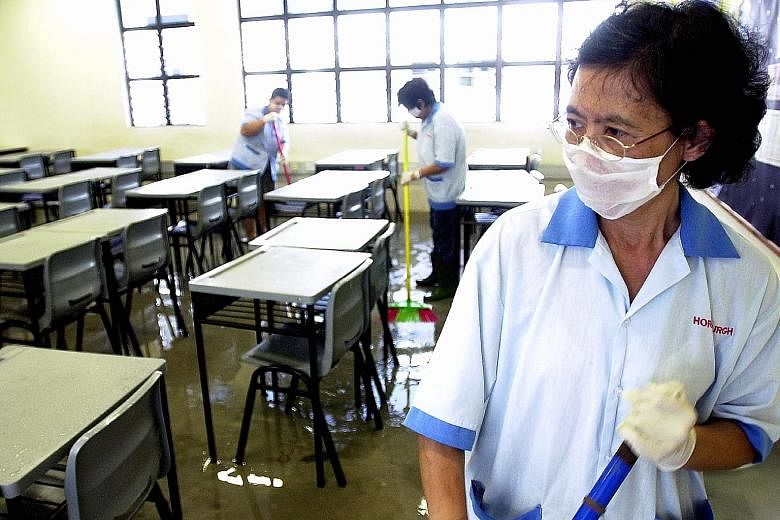 Cleaners disinfecting the floors of all the classrooms at Bowen Secondary School in an attempt to reduce the risk of infection during the Sars outbreak in Singapore, which lasted from March to July 2003.