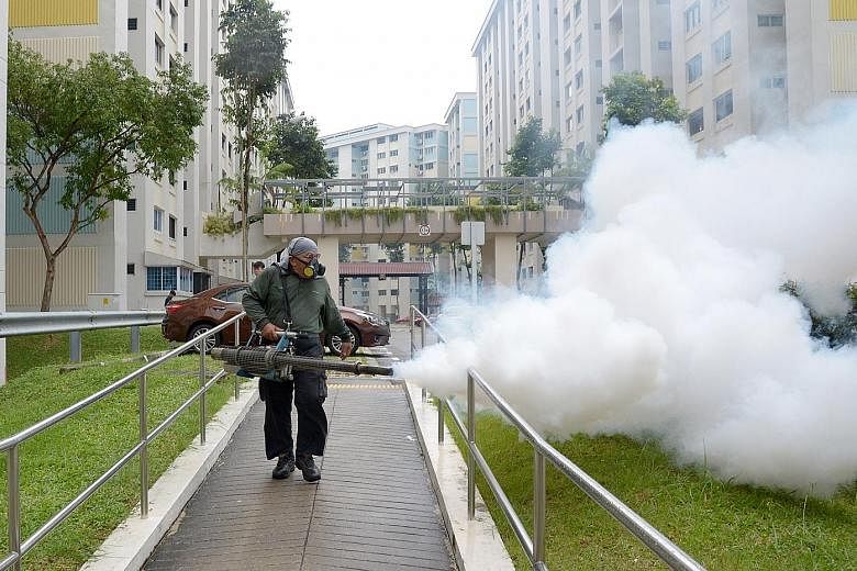 Fogging being done in a precinct at Bishan, after the Health Ministry confirmed the localised community spread of the Zika virus, which is transmitted primarily by the Aedes mosquito, on Aug 28, 2016. Passengers arriving from Qatar walking past a the