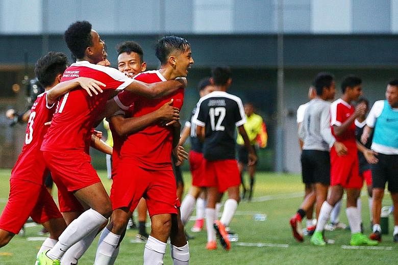 Singapore Sports School players (in red) celebrating on the way to beating Meridian Secondary School in the National School Games B Division final in April 2018. The sports school has won the B Division title eight times since 2007, and its recent 32