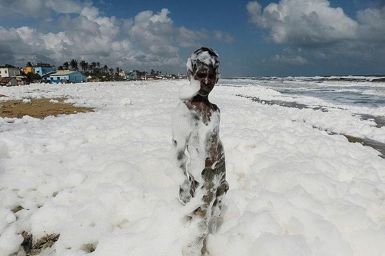 A youth standing in foamy discharge that has been caused by pollutants mixing with the surf at a Chennai beach, in November last year. India figured in the bottom five of 180 countries in 2019's Environmental Performance Index.
