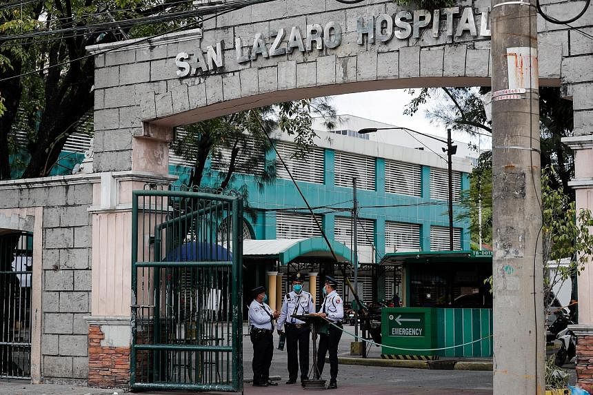 Security personnel standing guard yesterday at San Lazaro Hospital - where the first coronavirus death outside China was reported - in the Philippine capital Manila. The man and a woman had arrived from Wuhan on Jan 21.