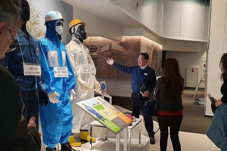 Tepco Decommissioning Archive Centre vice-director Shuichi Nakazato taking visitors on a tour of the centre.