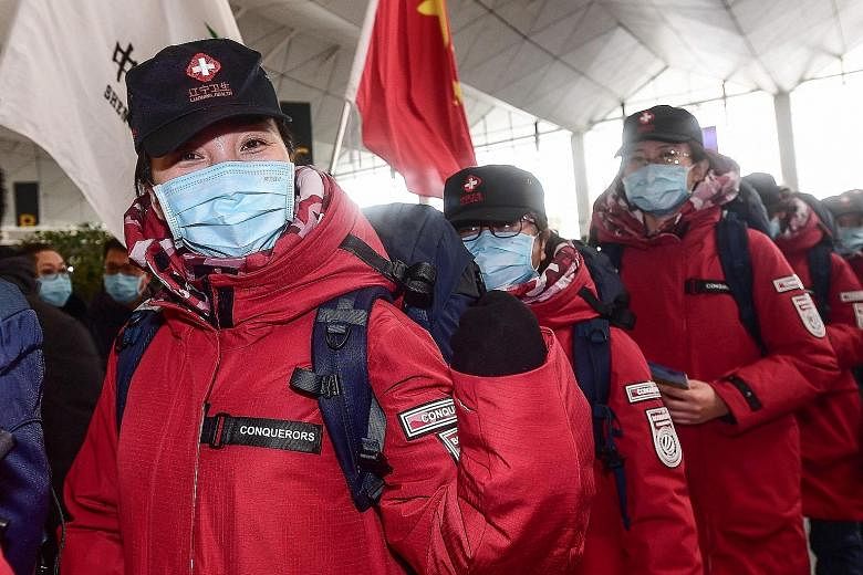 Medical workers from Shenyang, in China's Liaoning province, heading for Wuhan, the epicentre of the coronavirus outbreak, at the Xiantao International Airport on Sunday. Yesterday, the death toll in China hit 361, exceeding the 349 killed in mainlan