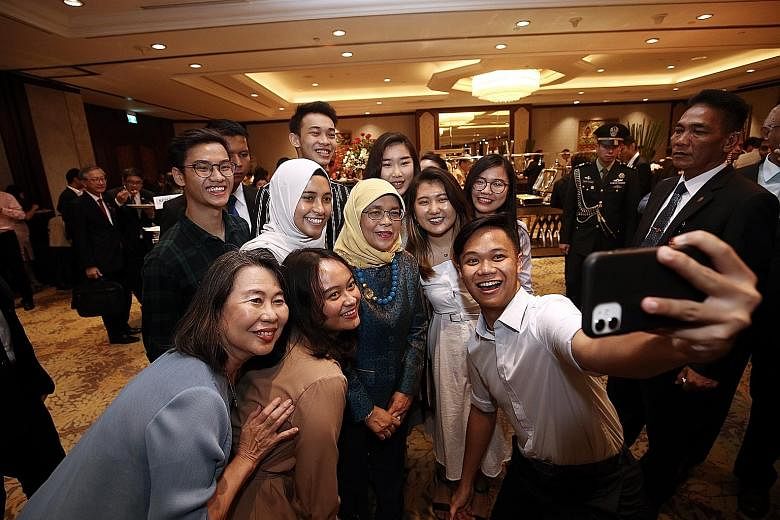 Ngee Ann Polytechnic students on internships with Indonesian companies taking a wefie with President Halimah Yacob at her reception with the Singapore community in Jakarta during her state visit to Indonesia. PHOTO: LIANHE ZAOBAO