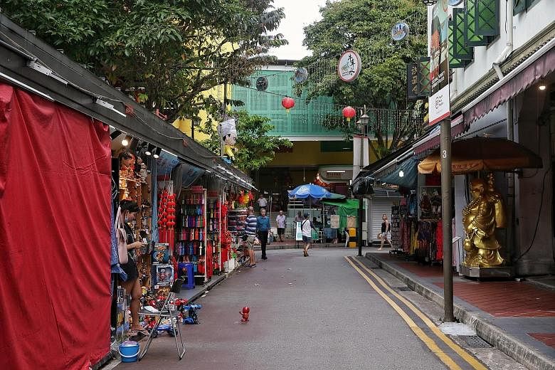 Sago Street in Chinatown was quieter than usual yesterday, as were other streets in the area. Some shop owners say they have seen a 50 per cent drop in sales and are bracing themselves for even worse times.