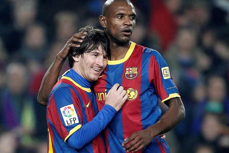 Eric Abidal congratulating Lionel Messi after his goal for Barcelona in a La Liga game against Atletico Madrid in February 2011. They played together for six years but appeared to have fallen out over the recent coaching change and tensions between p