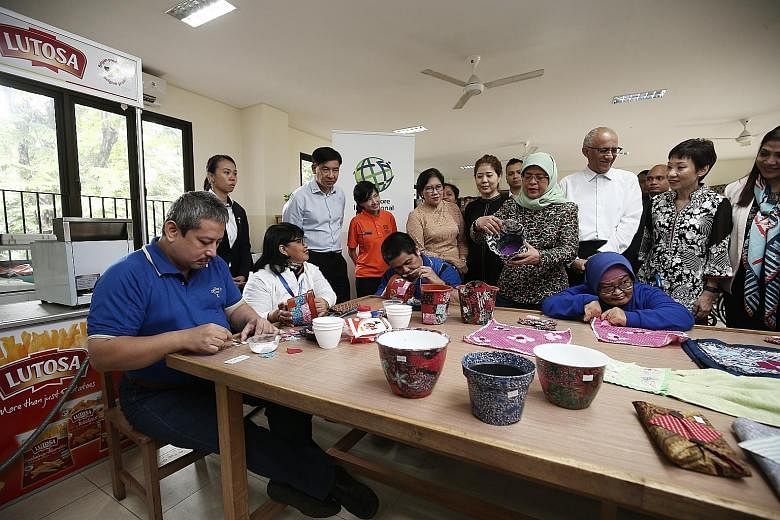 President Halimah Yacob at Singapore International Foundation's (SIF) occupational therapy session for those with special needs, in Jakarta, yesterday. With her were her husband Mohamed Abdullah Alhabshee; Minister for Culture, Community and Youth Gr