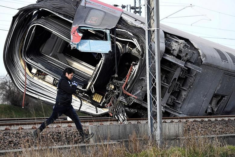 The wreckage of the high-speed train near Lodi, Italy, on Thursday. The train had skipped the tracks while travelling at an estimated 280kmh, with the front engine jumping onto an adjacent track and smashing into idle freight wagons. The train's two 