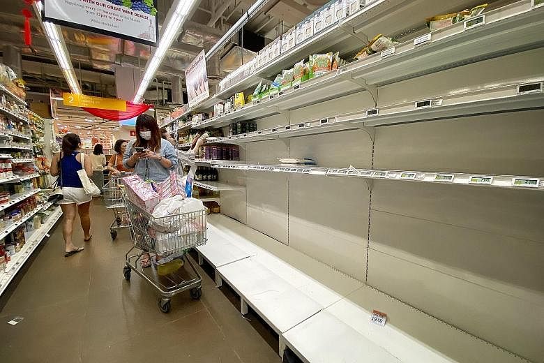 The FairPrice Finest outlet at myVillage in Serangoon Gardens. Toilet paper rolls, rice, instant noodles and cooking oil were among the items flying off supermarket shelves.