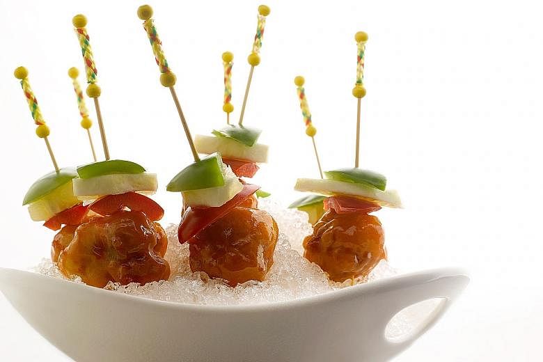 Kai Garden’s version (above) serves the pork cubes with pineapple and bell peppers and are skewered for easy eating.