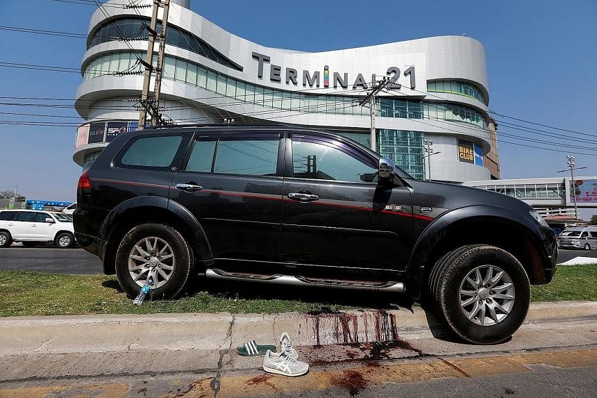 Above: At least 29 people were killed after a rogue soldier went on a shooting rampage at Terminal 21 mall in Nakhon Ratchasima, a four-hour drive from Bangkok. Below: A car belonging to a victim in front of the mall where the gunman staged a more th