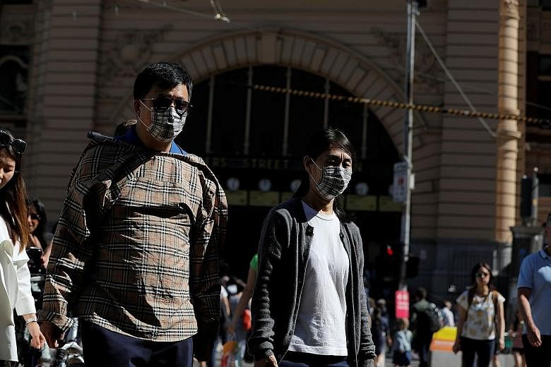 People wearing face masks at Flinders Street Station after cases of the coronavirus were confirmed in Melbourne. Australia's population of about 25 million includes more than 1.2 million people of Chinese heritage.