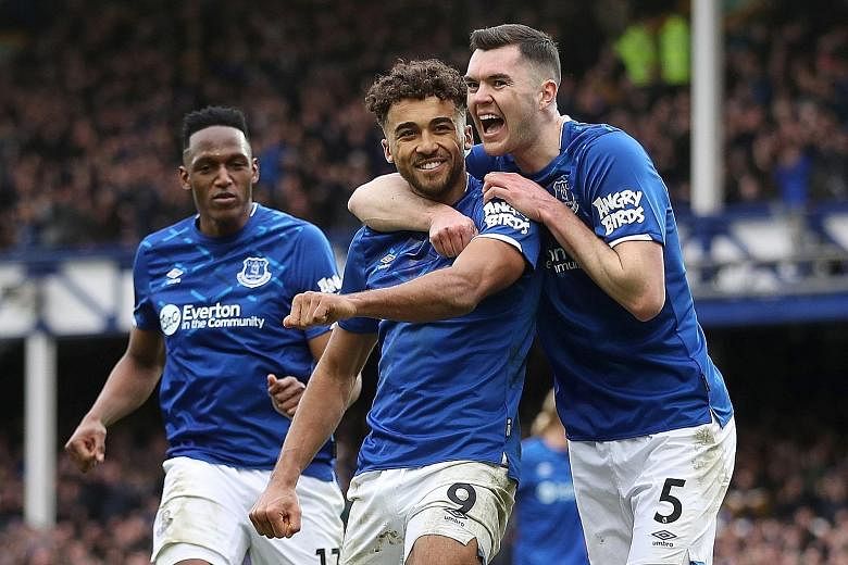 Dominic Calvert-Lewin (centre) celebrating his goal - and Everton's third - against Crystal Palace with Michael Keane and Yerry Mina (far left). Calvert-Lewin's 11 Premier League goals this season are the best by an English striker at Everton since A