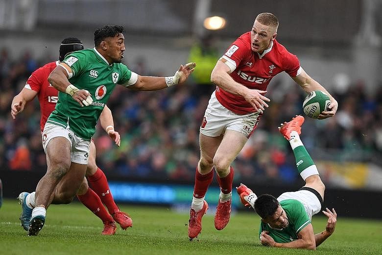 Irish players trying to stop Wales' prop Dillon Lewis during the Six Nations international rugby union match in Dublin on Saturday, which Ireland won 24-14. PHOTO: AGENCE FRANCE-PRESSE
