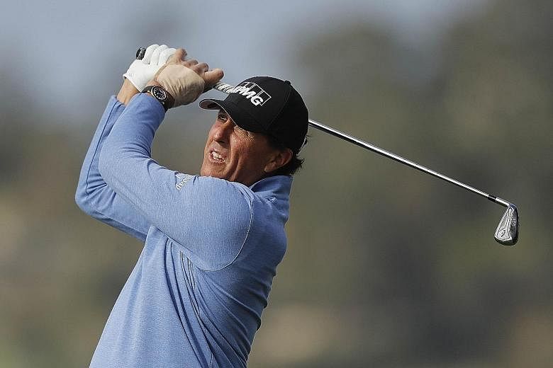 Phil Mickelson, a stroke behind leader Nick Taylor, is tied with Mark O'Meara on five wins in the Pebble Beach Pro-Am event. PHOTO: AGENCE FRANCE-PRESSE
