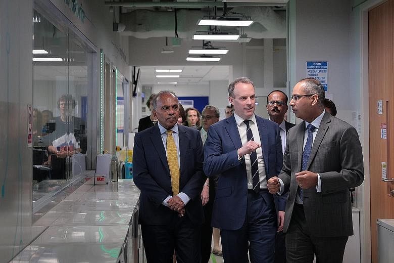 British Foreign Secretary Dominic Raab (centre) touring the Rolls-Royce corporate laboratory at Nanyang Technological University yesterday, flanked by Dr Bicky Bhangu (right), Rolls-Royce president for South-east Asia, Pacific and South Korea, and Pr