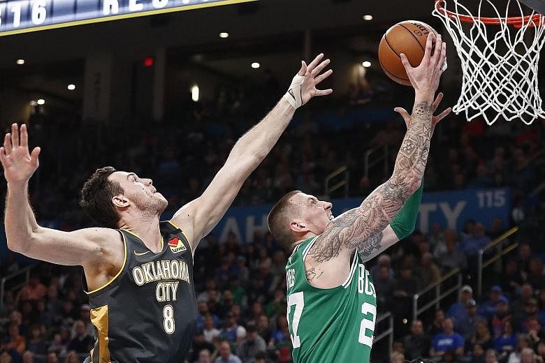 Boston starter Gordon Hayward sinking two of his 13 points of the night past Oklahoma City's Danilo Gallinari during their NBA game at Chesapeake Energy Arena on Sunday. Celtics extended their winning streak to seven games after the 112-111 triumph. 