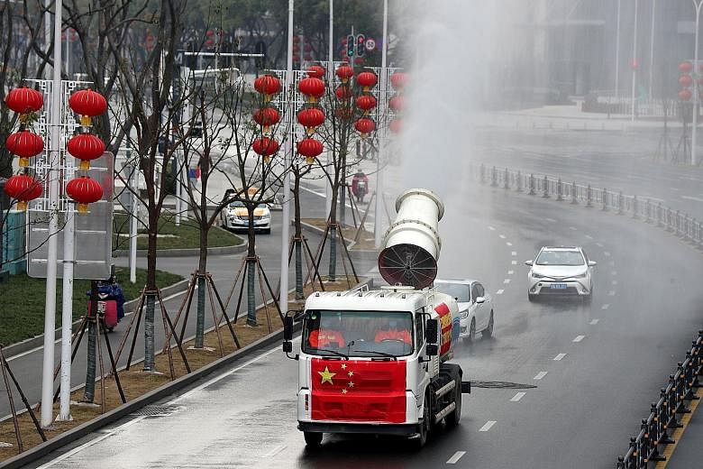Workers carrying out disinfection in the downtown area of Wuhan city's Jianghan district yesterday. Wuhan, the provincial capital city where the coronavirus first emerged, has a fatality rate of 4.06 per cent. It was topped by Tianmen, a nearby city,