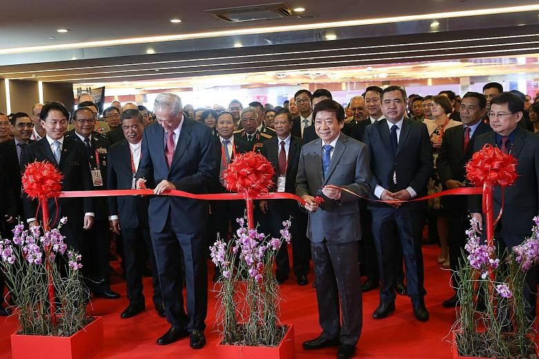 Defence Minister Ng Eng Hen (left) and Transport Minister Khaw Boon Wan jointly opened the Singapore Airshow 2020 at a ribbon-cutting ceremony yesterday. The ministers were then taken on a guided tour of the exhibits, stopping at local exhibitors suc