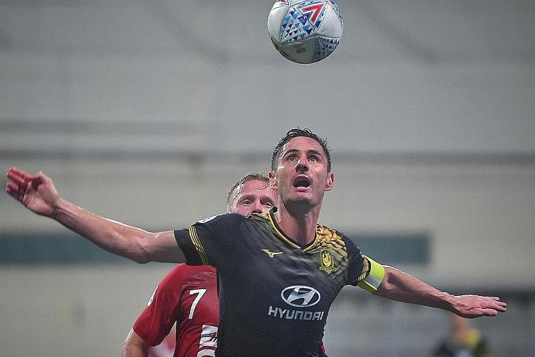 Tampines Rovers' Daniel Bennett keeping a watchful eye on the ball during their AFC Champions League play-off against Bali United. The Stags' defensive stalwart will be counted upon by coach Gavin Lee to shore up his side's rearguard. ST PHOTO: ARIFF