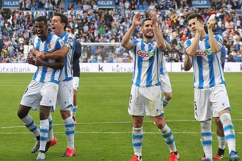 Real Sociedad players celebrating their 2-1 victory over Basque rivals Athletic Bilbao at Anoeta Stadium in San Sebastian on Sunday. Six Sociedad starters were nurtured at their Zubieta academy. PHOTO: EPA-EFE