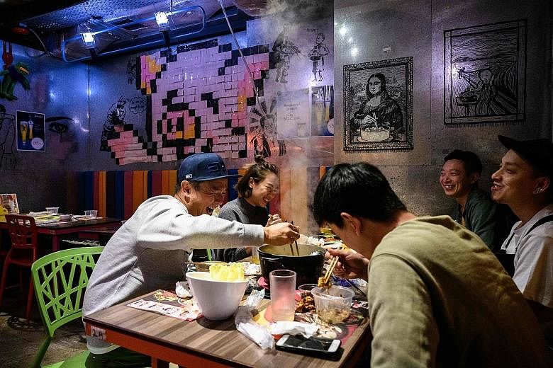 Family-run restaurant 66 Hotpot (above), in the bustling district of Mongkok in Hong Kong, has seen some 20 customers cancelling their bookings, following news reports of a family cluster affected by the coronavirus after sharing hot pot.