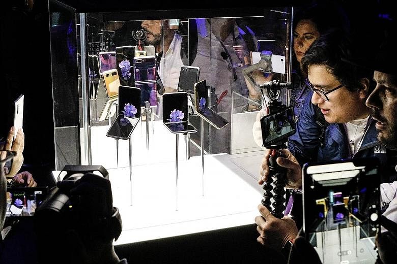 Samsung's Galaxy Z Flip folding smartphone on display in San Francisco, California, on Tuesday. Its clamshell design is a departure from the electronics maker's first foldable phone, the Galaxy Fold, launched last September. PHOTO: AGENCE FRANCE-PRES
