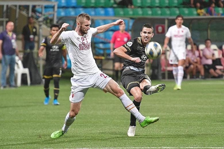Tampines Rover striker Boris Kopitovic (right) squaring off against PSM Makassar midfielder Serif Hasic during their AFC Cup Group H match at the Jalan Besar Stadium last night. Goals by Jordan Webb (24th minute) and Kopitovic (64th) gave the dominan