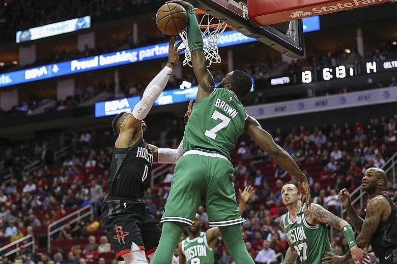 Boston's Jaylen Brown blocking Houston's Russell Westbrook at the basket. It was a rare rejection, with Westbrook running riot with 36 points in Houston's 116-105 NBA victory. PHOTO: REUTERS
