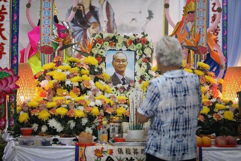 Left: A visitor paying respects at the wake of the late Mr Kee Kin Tiong last month. Mr Kee's body was mistakenly sent to Mandai Crematorium instead of a 70-year-old man's. He was cremated according to Christian funeral rites, when he was in fact Tao