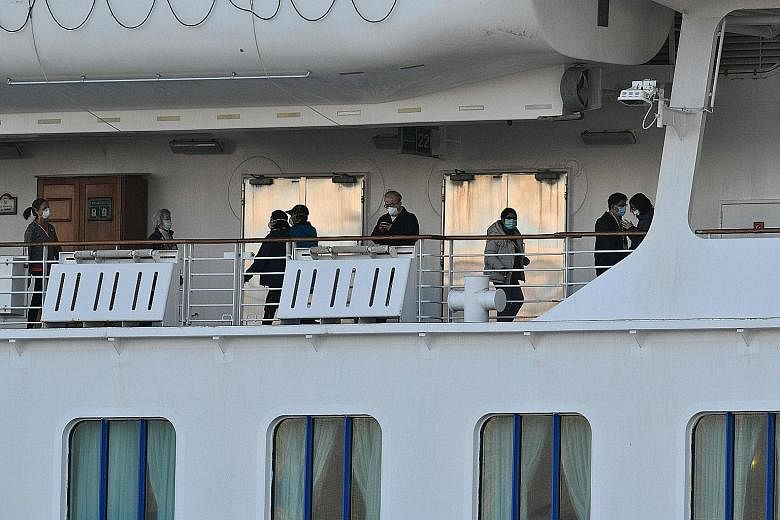 Left: Passengers on the deck of the Diamond Princess, which has the single largest cluster of infected people outside China. Right: The Westerdam arriving in Sihanoukville, on Cambodia's southern coast, yesterday. It had been turned away from several