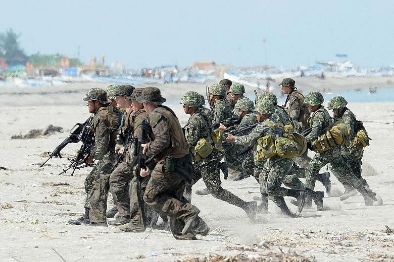 A file photo from May 2014 of Philippine and US Marines at a beach exercise facing the South China Sea. President Rodrigo Duterte has announced the termination of the Visiting Forces Agreement, which sets out rules for US soldiers in his country. PHO