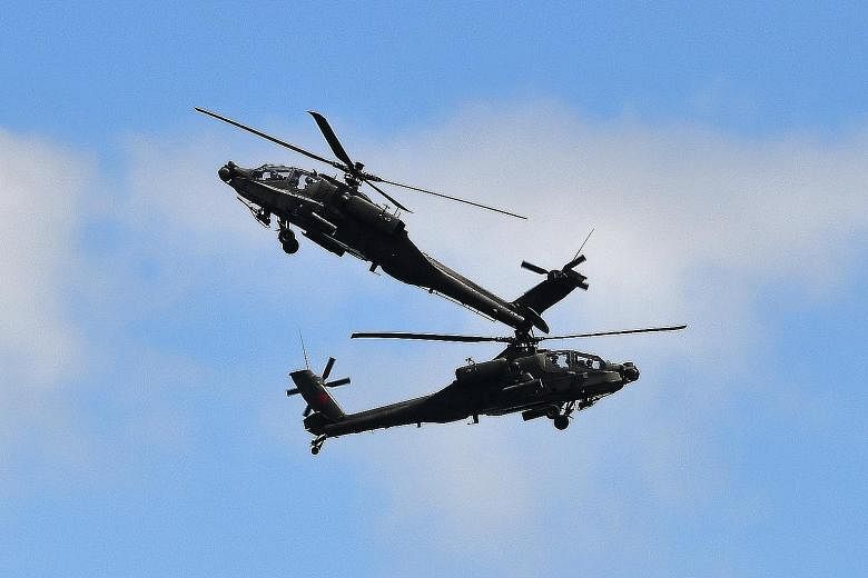 Far left: The Republic of Singapore Air Force's two AH-64D attack helicopters in action during a performance. Left: China's People's Liberation Army Air Force aerobatics team Ba Yi performing daredevil aerobatics.