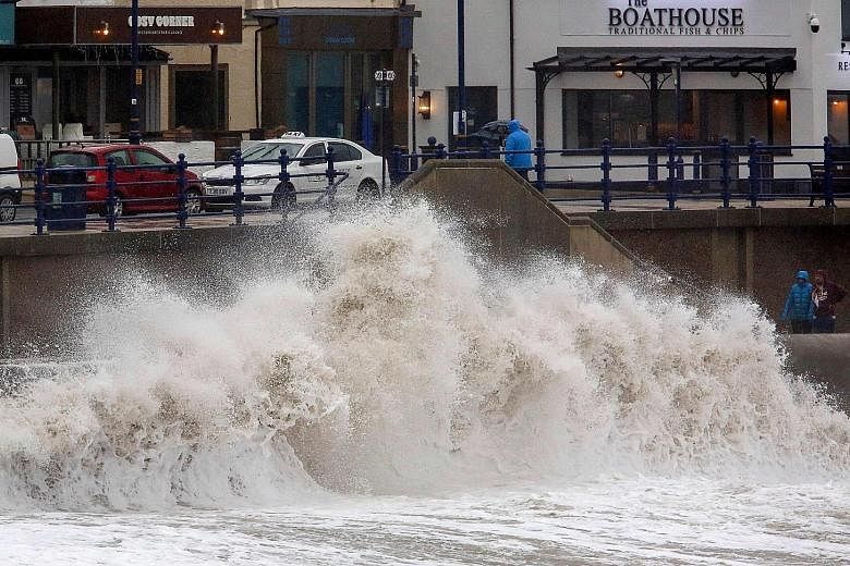 Huge waves crashing against a sea wall at Porthcawl, south Wales, as Storm Dennis swept into Britain yesterday. The country braced itself for widespread weather disruption for the second weekend in a row after the recent Storm Ciara. Hundreds of flig