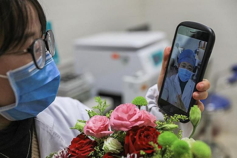 A doctor being disinfected by his colleague earlier this month in a quarantine zone in Wuhan, the city in China's central Hubei province that is the epicentre of the coronavirus outbreak. A People's Liberation Army medical team starting work on Jan 2