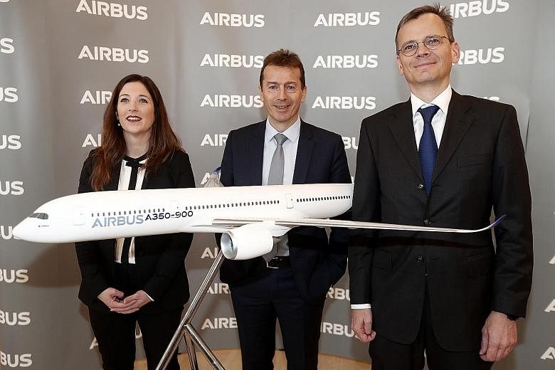 Airbus chief executive Guillaume Faury (centre) with executive vice-president for communications and corporate affairs Julie Kitcher and chief financial officer Dominik Asam at a media conference on its financial results in Blagnac, in southern Franc